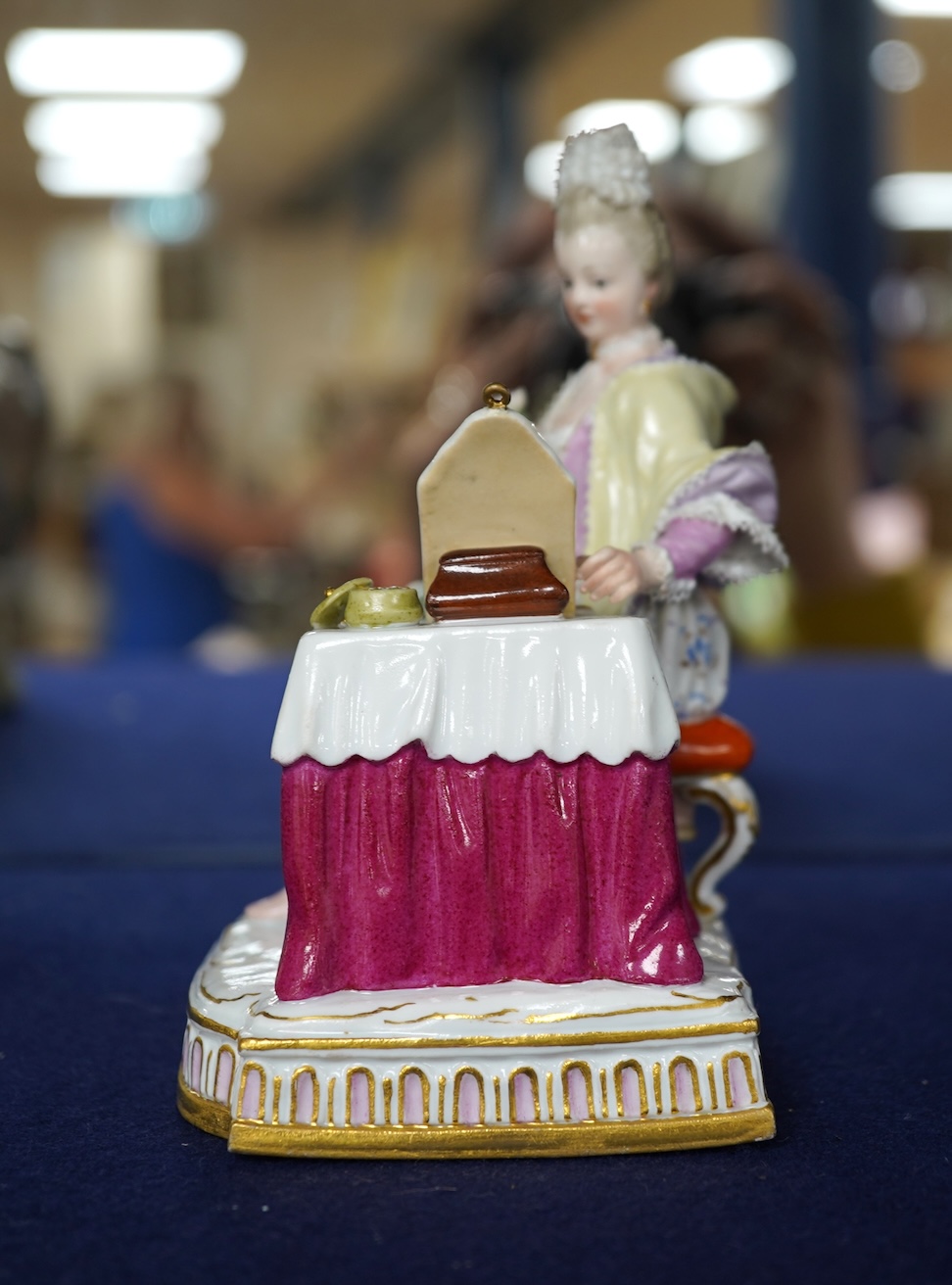 A late 19th century Meissen figure of Sight, from the Senses, a seated lady at her dressing table, crossed swords mark and incised E3 mark to base, 14cm high